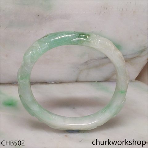 Carved light green jade bangle