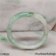 Carved light green jade bangle