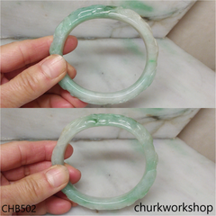 Carved light green jade bangle