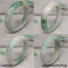 Carved light green jade bangle